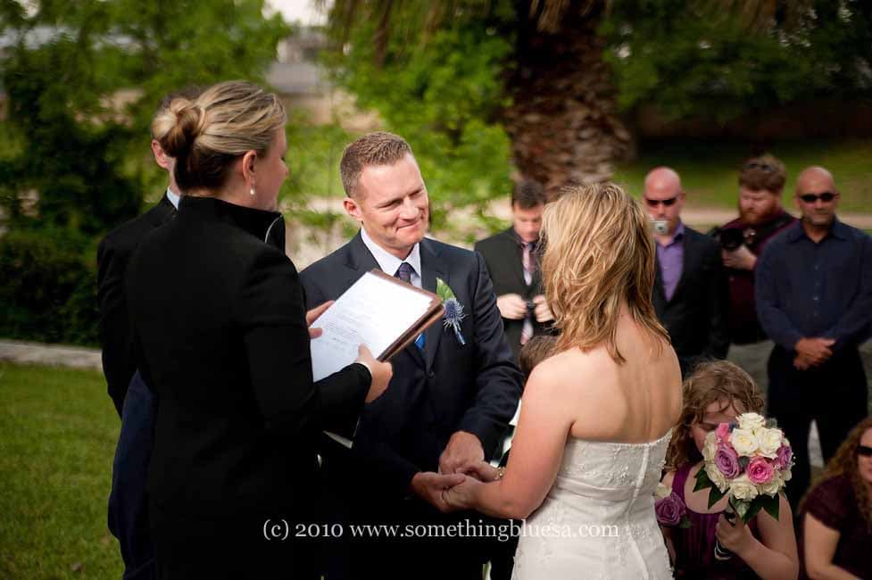 A couple exchanges vows during an outdoor wedding ceremony.